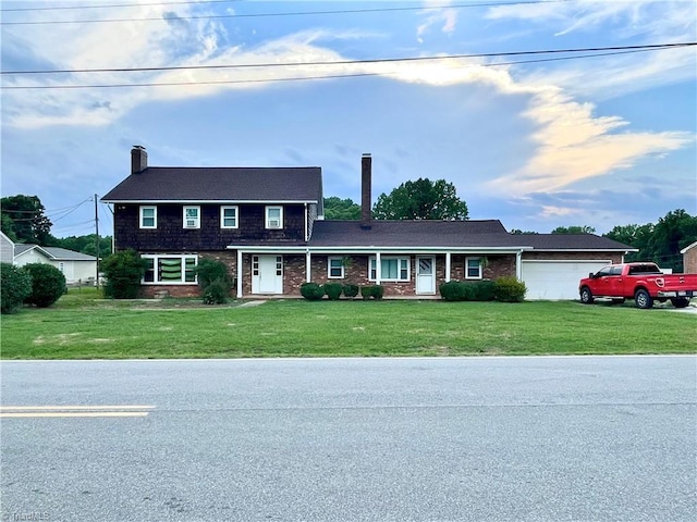 view of front of property with a garage and a front lawn