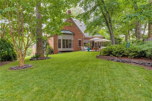 3705 Bradwyck Cir, Winston-Salem, NC 27104 - rear view of property featuring brick siding, a lawn, a patio, and a chimney