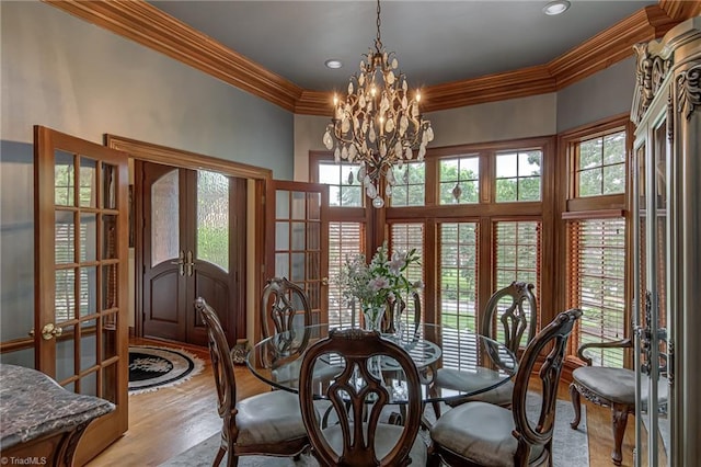 3705 Bradwyck Cir, Winston-Salem, NC 27104 - dining space with french doors, crown molding, light wood-style floors, and a chandelier