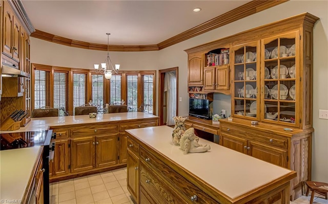 3705 Bradwyck Cir, Winston-Salem, NC 27104 - kitchen with stainless steel electric range, a chandelier, brown cabinetry, light countertops, and a center island