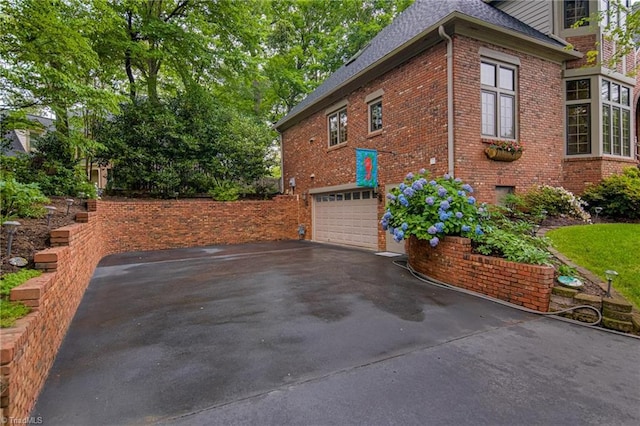 3705 Bradwyck Cir, Winston-Salem, NC 27104 - view of property exterior featuring brick siding, a shingled roof, driveway, and an attached garage