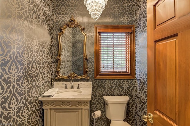 3705 Bradwyck Cir, Winston-Salem, NC 27104 - bathroom with wallpapered walls, vanity, toilet, and a chandelier