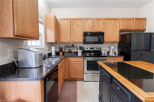 kitchen with sink, black appliances, and dark stone counters