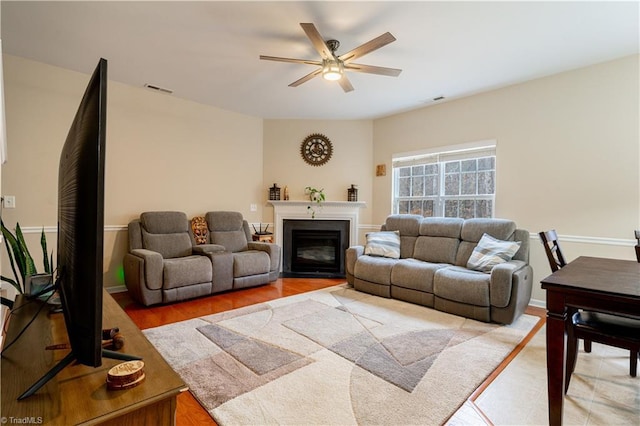 living room featuring hardwood / wood-style floors and ceiling fan