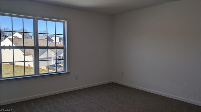 carpeted spare room featuring a wealth of natural light