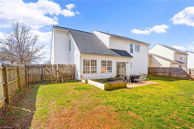 rear view of house with roof with shingles, a lawn, a patio area, and a fenced backyard