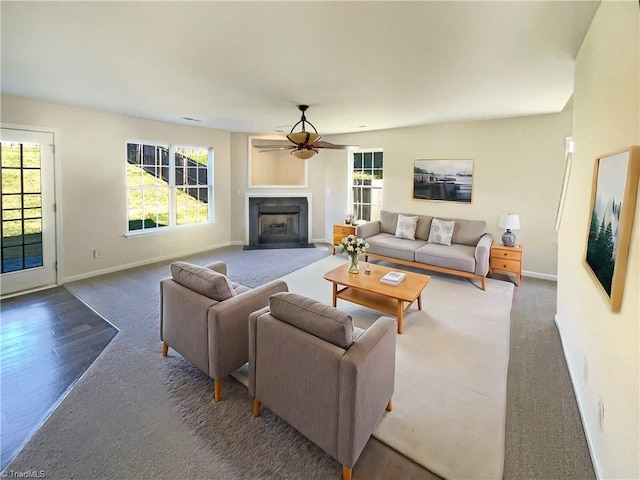 carpeted living room with ceiling fan