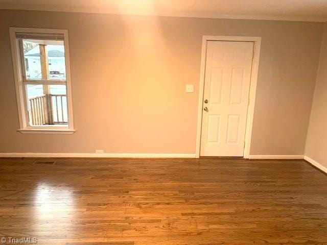 unfurnished room featuring hardwood / wood-style flooring