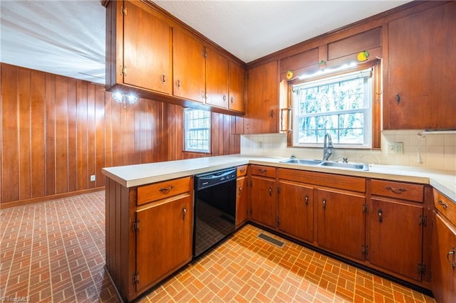 kitchen featuring a sink, black dishwasher, and brown cabinetry