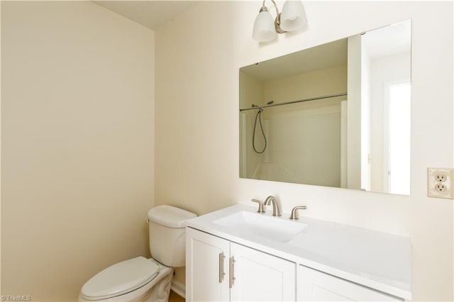 full bathroom featuring vanity, toilet, and walk in shower