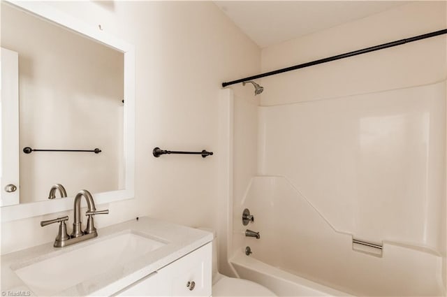 bathroom with toilet, washtub / shower combination, and vanity