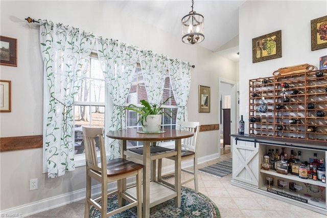 dining area featuring a notable chandelier and vaulted ceiling