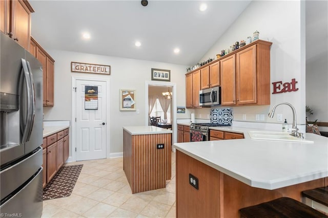 kitchen with a kitchen island, a breakfast bar, kitchen peninsula, sink, and stainless steel appliances