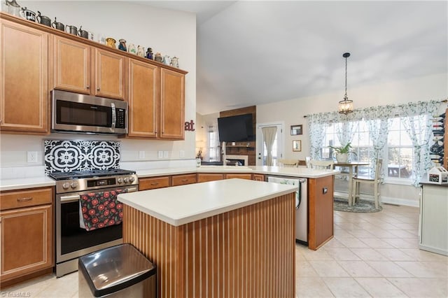 kitchen with a kitchen island, kitchen peninsula, hanging light fixtures, stainless steel appliances, and light tile patterned floors