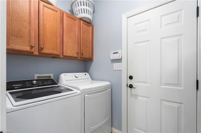 laundry room with cabinets and washing machine and clothes dryer