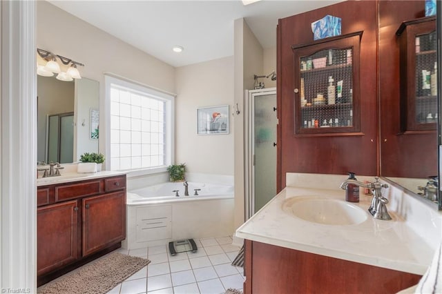 bathroom featuring plus walk in shower, tile patterned floors, and vanity