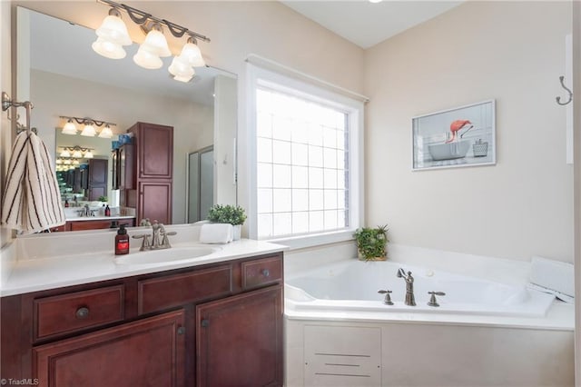 bathroom featuring independent shower and bath and vanity