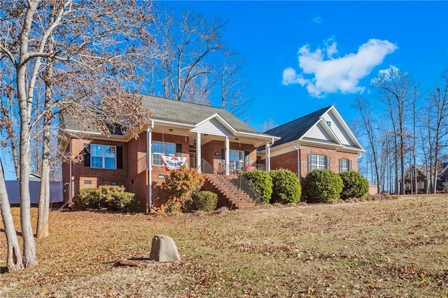 view of front of house featuring a porch and a front yard