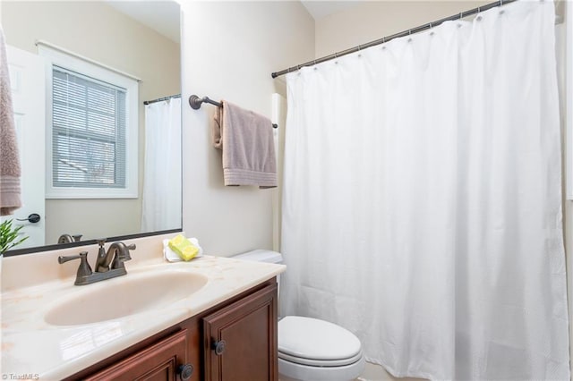 bathroom featuring toilet and vanity