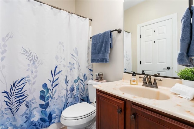 bathroom featuring toilet and vanity