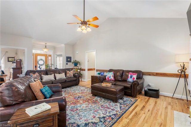 living room with vaulted ceiling, ceiling fan, and hardwood / wood-style flooring