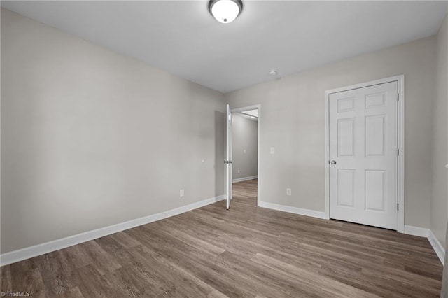 unfurnished bedroom featuring baseboards and wood finished floors