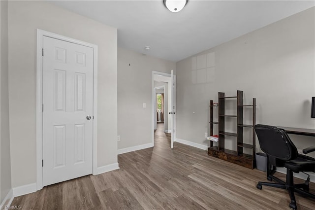 office featuring baseboards and wood finished floors