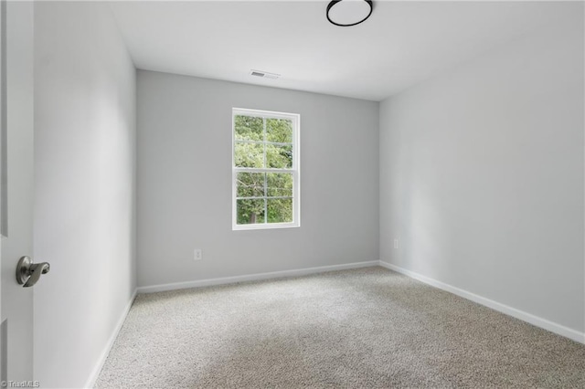 empty room featuring carpet floors and baseboards