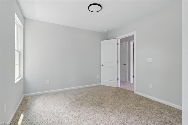 spare room with carpet flooring and baseboards