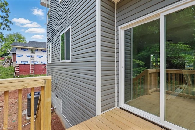 wooden deck with central air condition unit