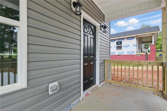 view of exterior entry with a porch