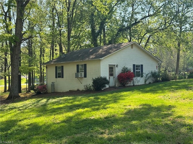 view of side of home featuring a yard and cooling unit
