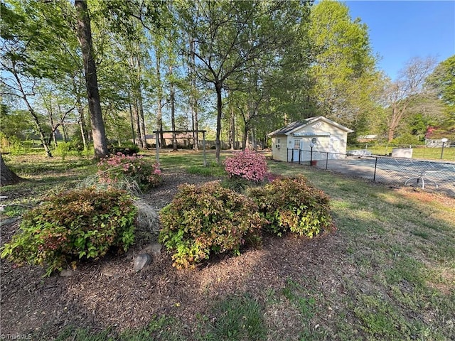 view of yard with fence and an outbuilding