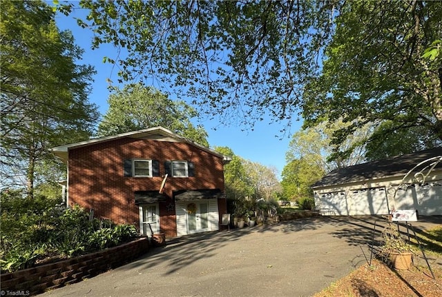 view of front facade with brick siding and driveway