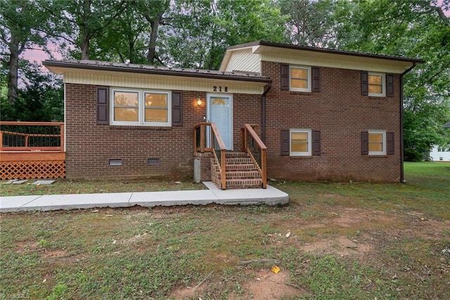 split level home with a lawn and a deck