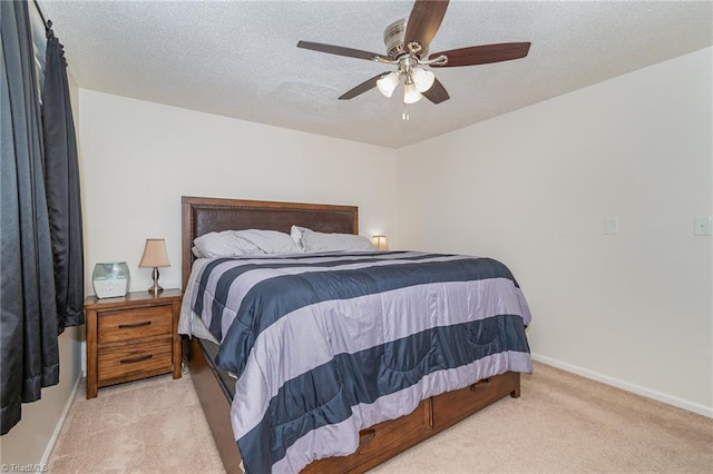 carpeted bedroom with a textured ceiling and ceiling fan