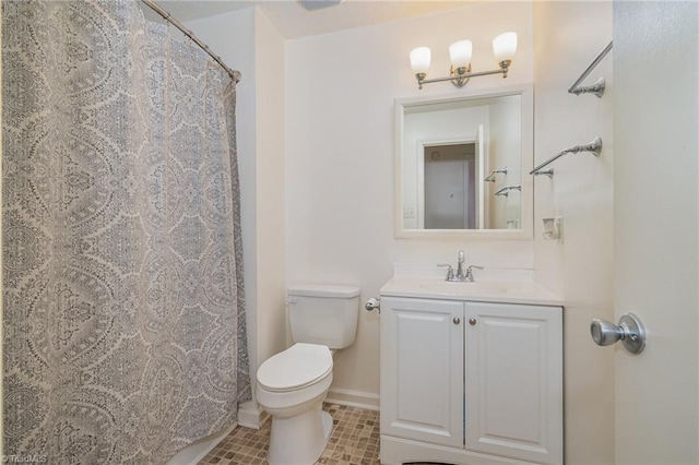 bathroom featuring tile patterned floors, vanity, and toilet