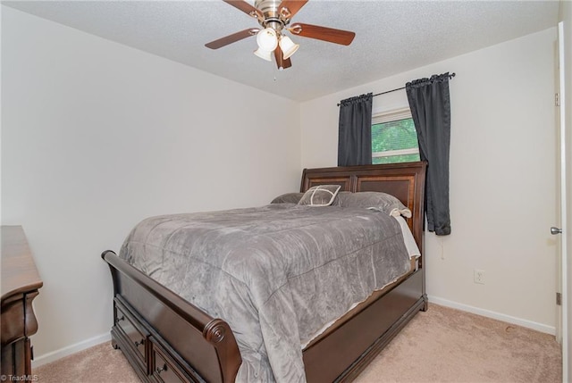 carpeted bedroom featuring a textured ceiling and ceiling fan