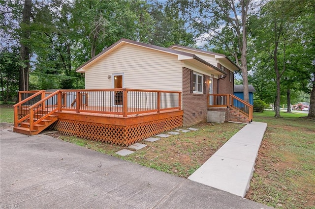 view of property exterior with a yard and a wooden deck