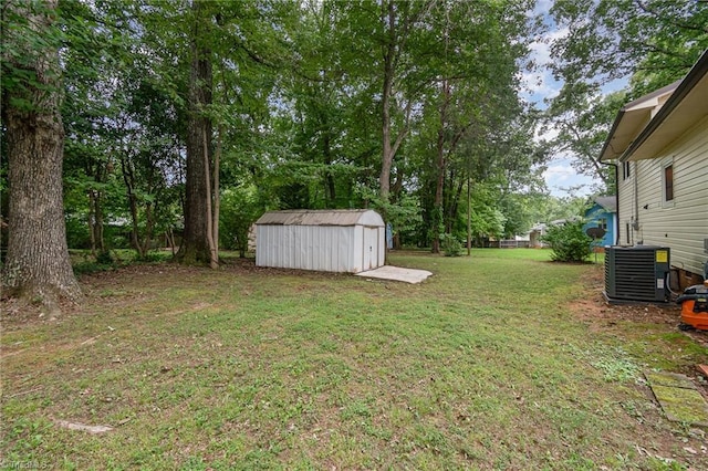 view of yard featuring central AC unit and a storage shed