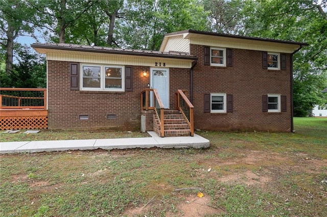 view of front of home with a front lawn and a wooden deck