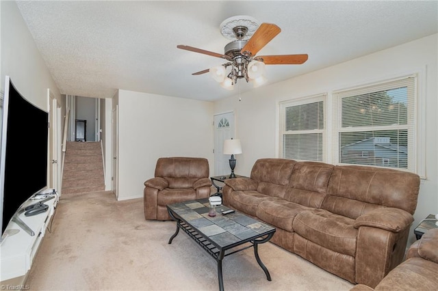 carpeted living room with ceiling fan