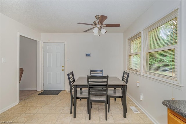 dining room featuring light tile patterned floors and ceiling fan