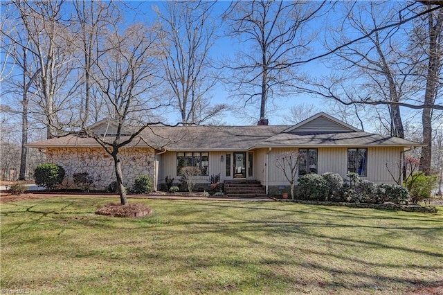 view of front of house featuring a front yard, stone siding, and a chimney