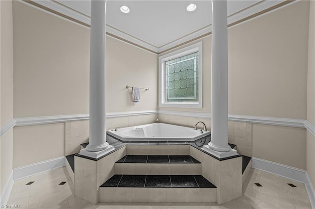 bathroom with ornate columns, tile patterned flooring, a garden tub, baseboards, and ornamental molding