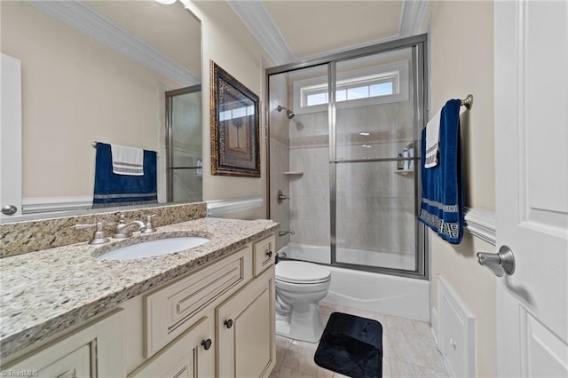bathroom with ornamental molding, toilet, vanity, and shower / bath combination with glass door