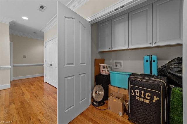 laundry area featuring ornamental molding, washer hookup, light wood finished floors, recessed lighting, and baseboards