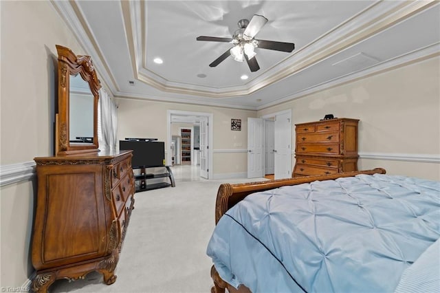 carpeted bedroom with ornamental molding, a raised ceiling, and recessed lighting