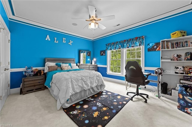 carpeted bedroom with ornamental molding, baseboards, and a ceiling fan