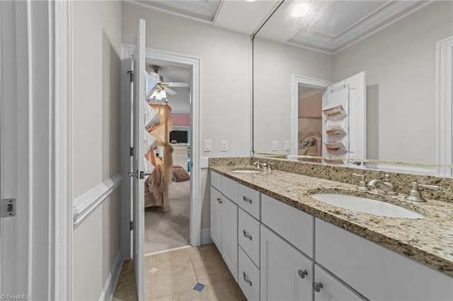 ensuite bathroom with tile patterned flooring, double vanity, and ornamental molding